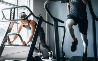 woman in black tank top and black shorts sitting on black exercise equipment